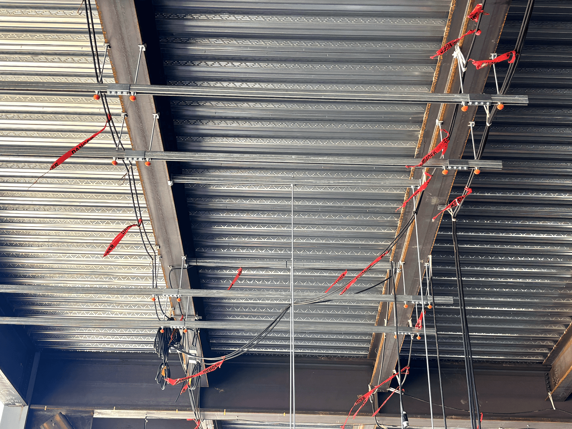 MagGuard® properly installed on overhead threaded rods on an active job site